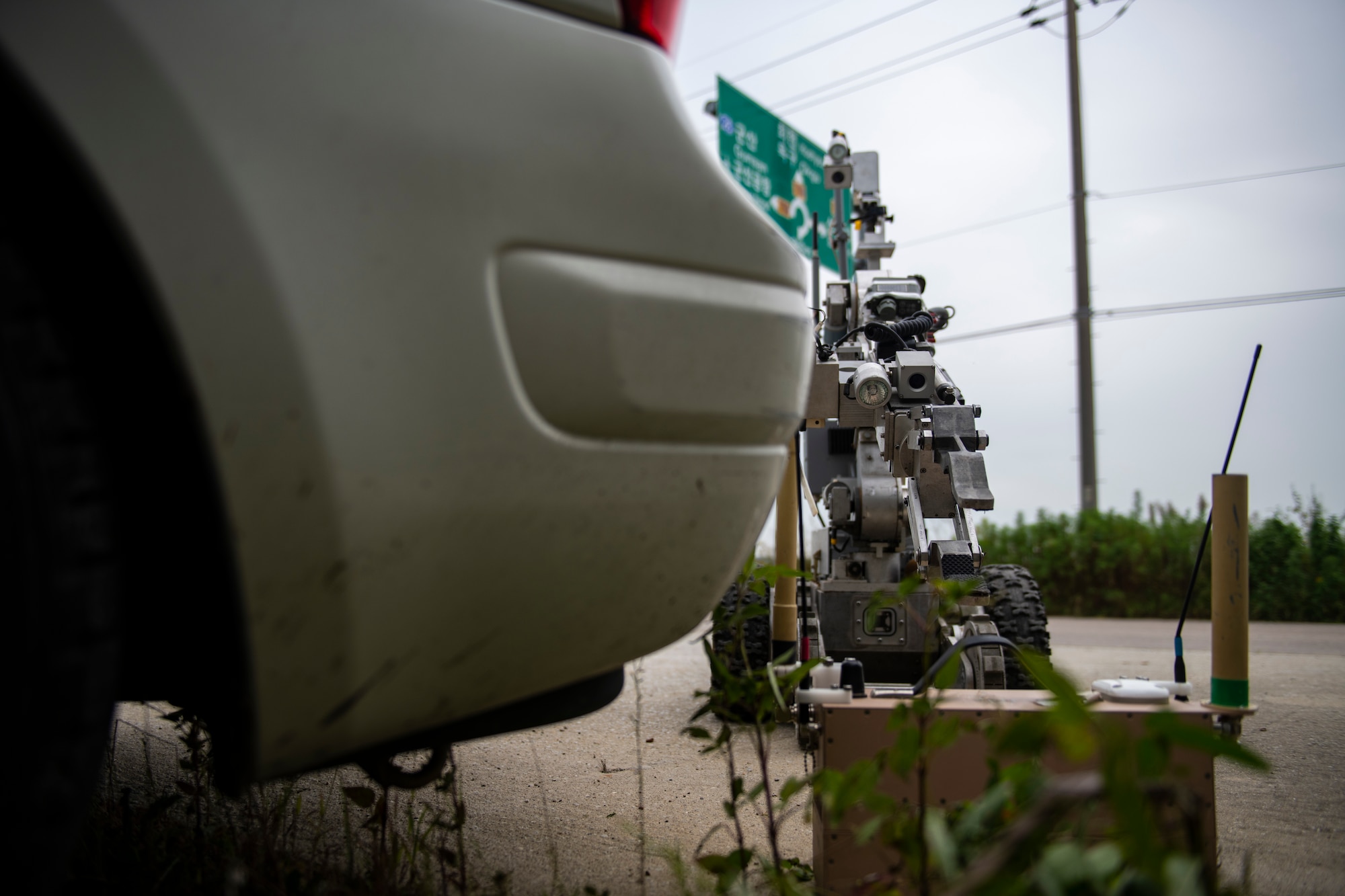 An Andros F6 Robot advances toward a vehicle with a suspected ordnance item during a simulated training exercise at Kunsan Air Base, Republic of Korea, Sept. 28, 2021. The robot uses several cameras to give explosive ordnance disposal technicians a clear view of the threat and increases their ability to complete tasks in a dangerous environment. (U.S. Air Force photo by Senior Airman Suzie Plotnikov)