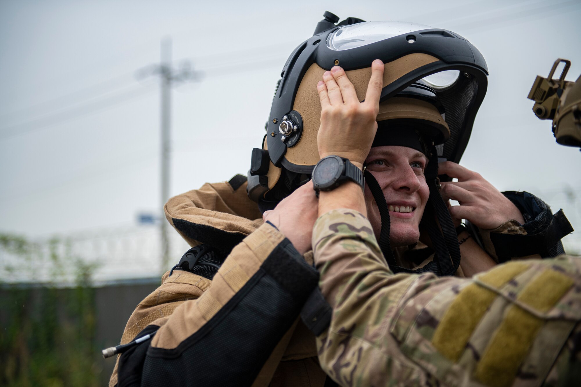 Staff Sgt. Mark White, 8th Civil Engineer Squadron explosive ordnance disposal technician, puts on a bomb suit during a simulated training exercise at Kunsan Air Base, Republic of Korea, Sept. 28, 2021. The bomb suit is an EOD technician's full-body shield and sole source of protection against an explosive threat. (U.S. Air Force photo by Senior Airman Suzie Plotnikov)