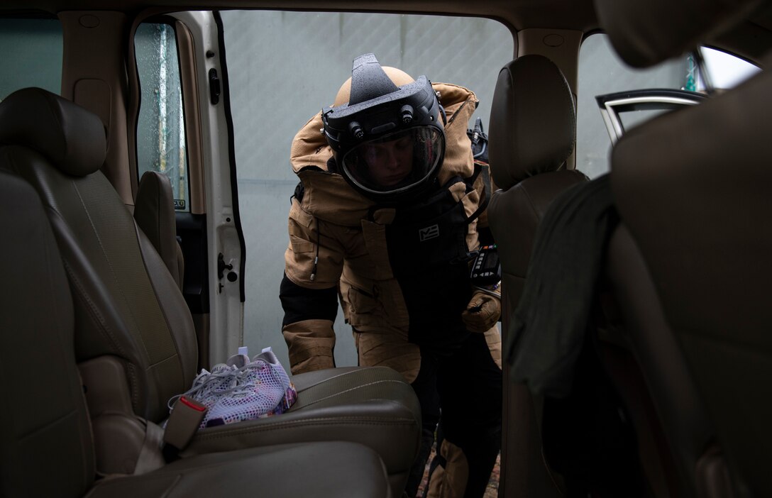 Staff Sgt. Mark White, 8th Civil Engineer Squadron explosive ordnance disposal technician, checks a vehicle for a suspected ordnance item during a simulated training exercise at Kunsan Air Base, Republic of Korea, Sept. 28, 2021. EOD technicians are trained to detect, disarm and dispose of explosive threats in the most extreme environments and are assigned to dangerous missions in diverse environments worldwide. (U.S. Air Force photo by Senior Airman Suzie Plotnikov)