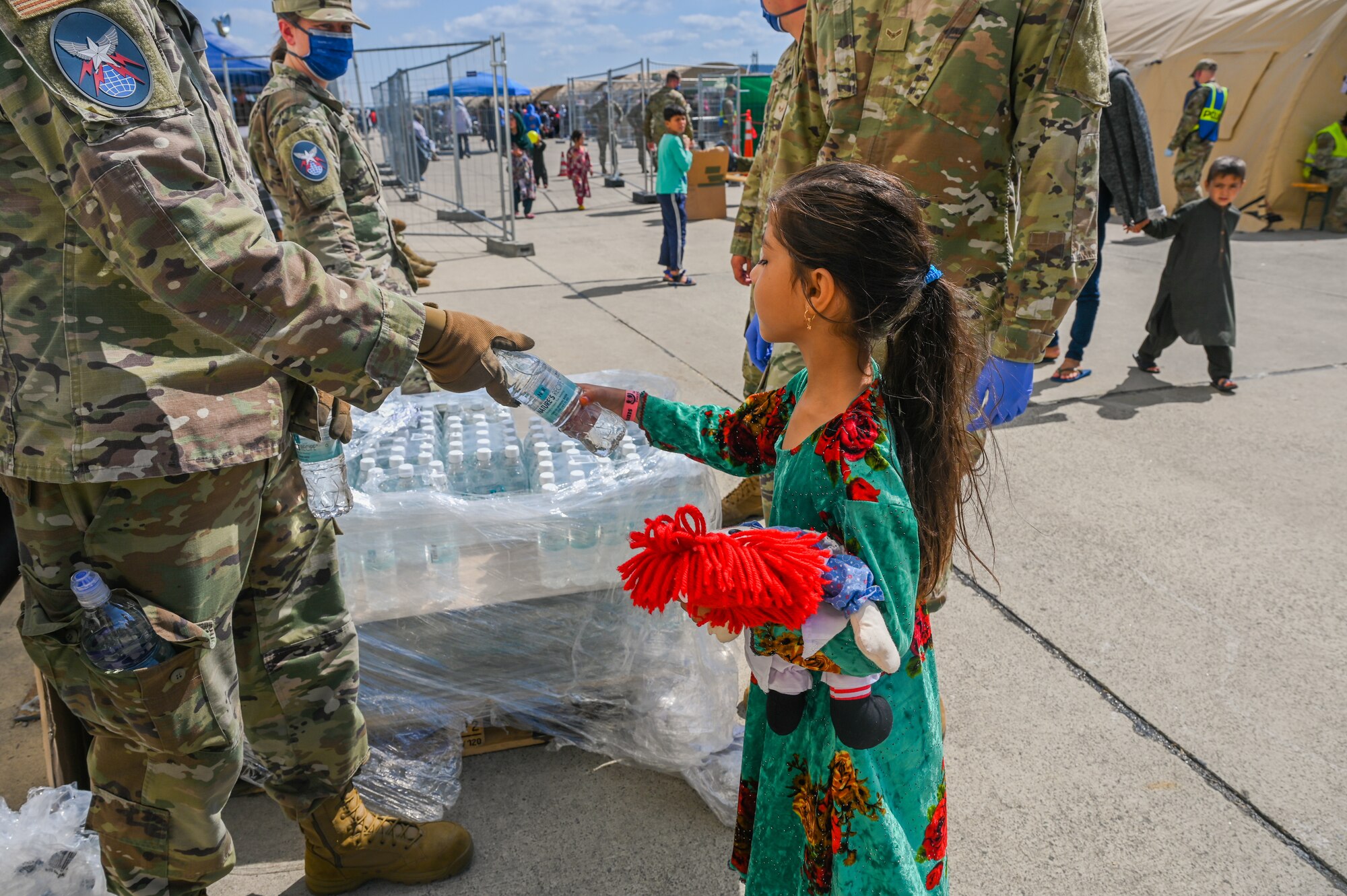 Service member hand girl water