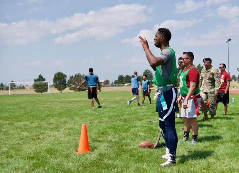 Members of Schriever Space Force Base, Colorado, react on the sidelines of flag football during the biannual Wingman Day, Aug. 6, 2021. After a commander’s kick off, Wingman Day included an obstacle course, flag football, kickball, dodgeball, volleyball, tug-of-war, dancing and leisurely lawn games. (U.S. Space Force Photo by Kristian DePue)