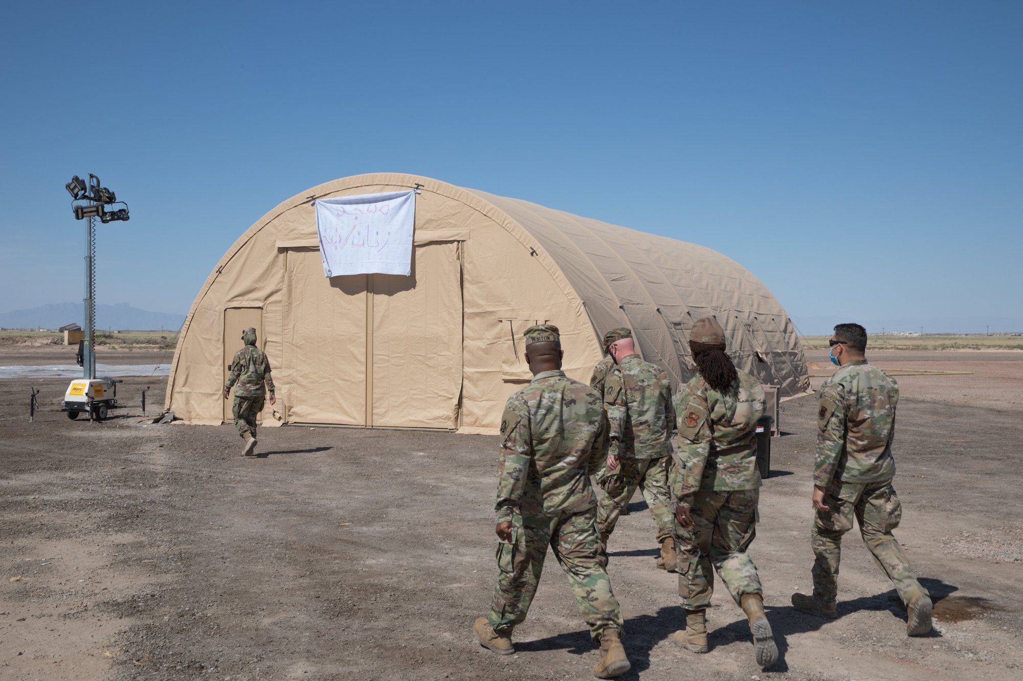 Military service members visit the prayer facilities at Aman Omid Village as part of a tour through Task Force-Holloman’s support to Operation Allies Welcome on Holloman Air Force Base, New Mexico, Sept. 22, 2021. The Department of Defense, through the U.S. Northern Command, and in support of the Department of State and Department of Homeland Security, is providing transportation, temporary housing, medical screening, and general support for at least 50,000 Afghan evacuees at suitable facilities, in permanent or temporary structures, as quickly as possible. This initiative provides Afghan evacuees essential support at secure locations outside Afghanistan. (U.S. Army photo by Spc. Nicholas Goodman)