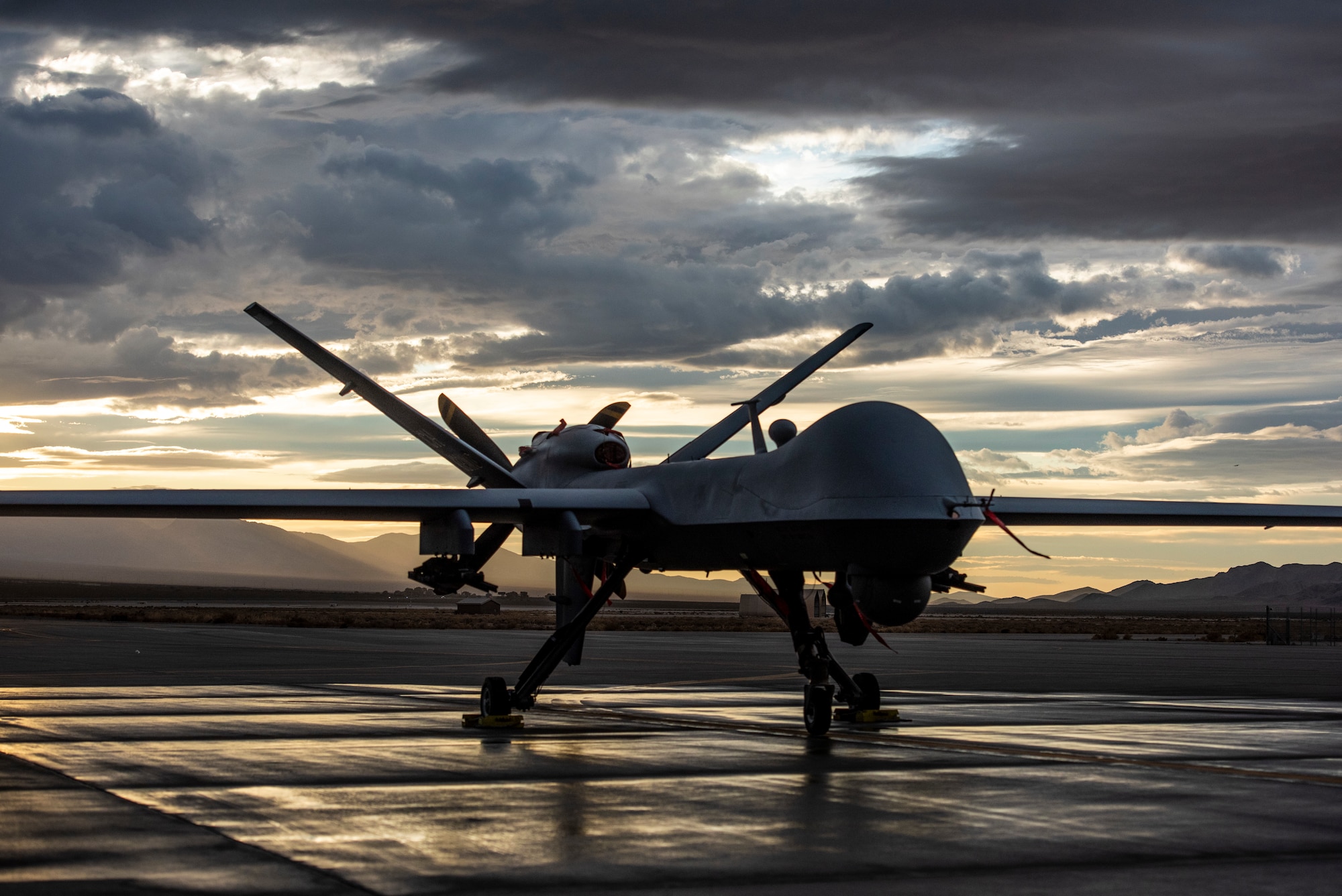 An MQ-9 Reaper sits on the flight line as the sun sets at Creech Air Force Base