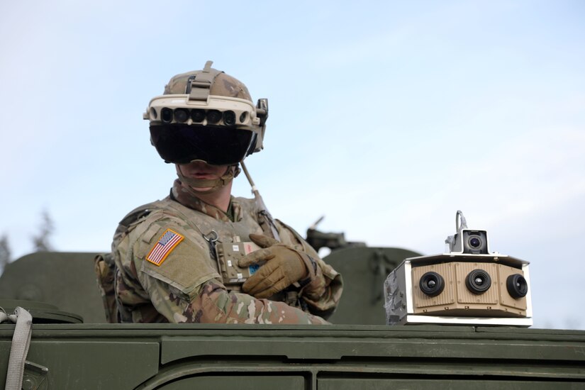 soldier wearing an advanced goggle system stands peering out of