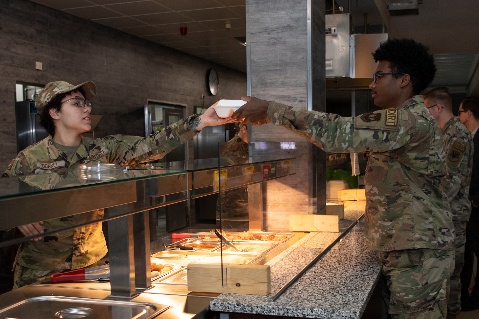 Airman serving lunch to another Airman at Spangdahlem Air Base, Germany.