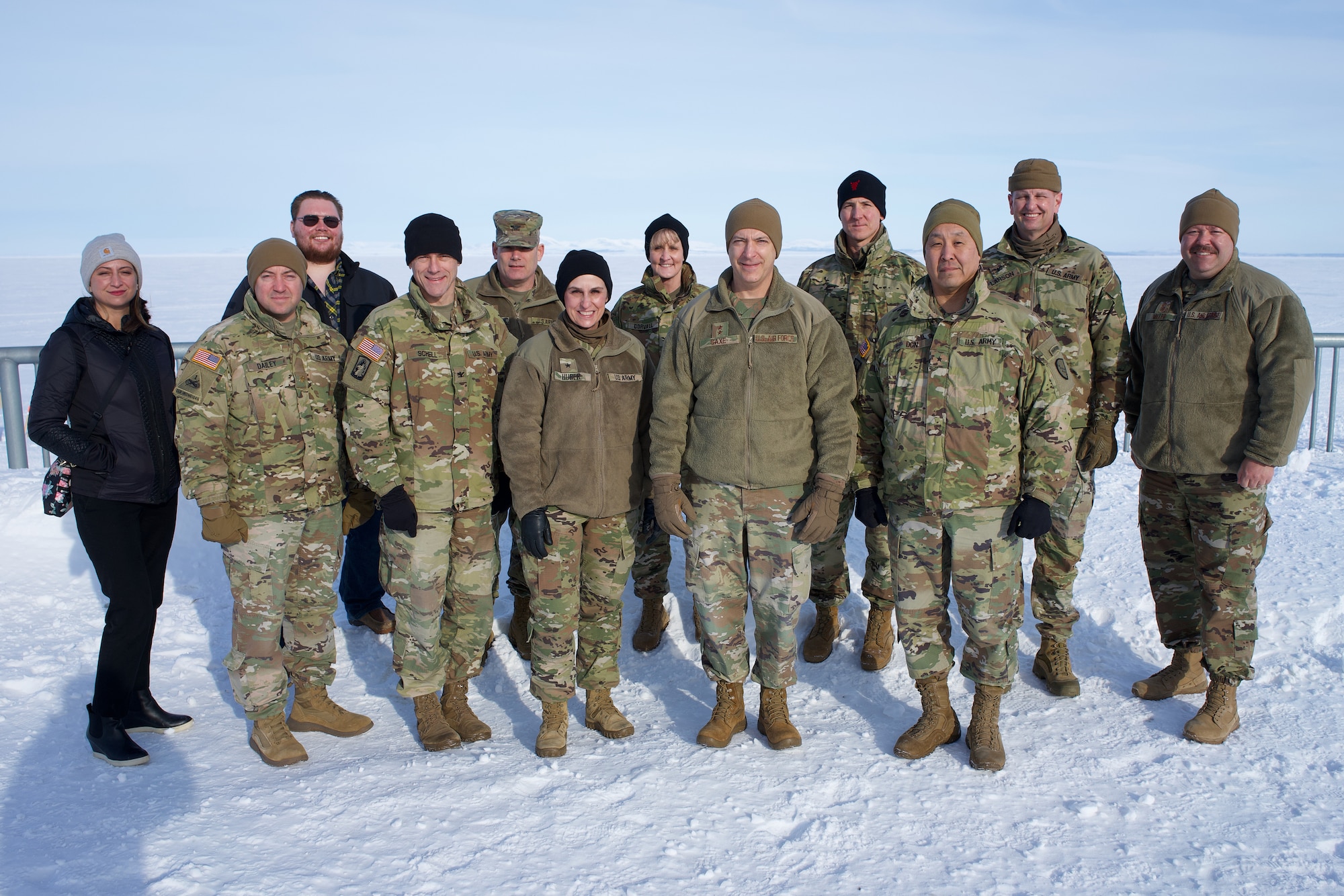 National Guard Arctic Interest Council delegates representing the Alaska, Michigan, Minnesota, Montana, New Hampshire and North Dakota National Guard and the National Guard Bureau stand at the Kotzebue, Alaska, sea wall overlooking the frozen Chukchi Sea March 29, 2022. The $34 million sea wall was constructed to address soil erosion from climate change.