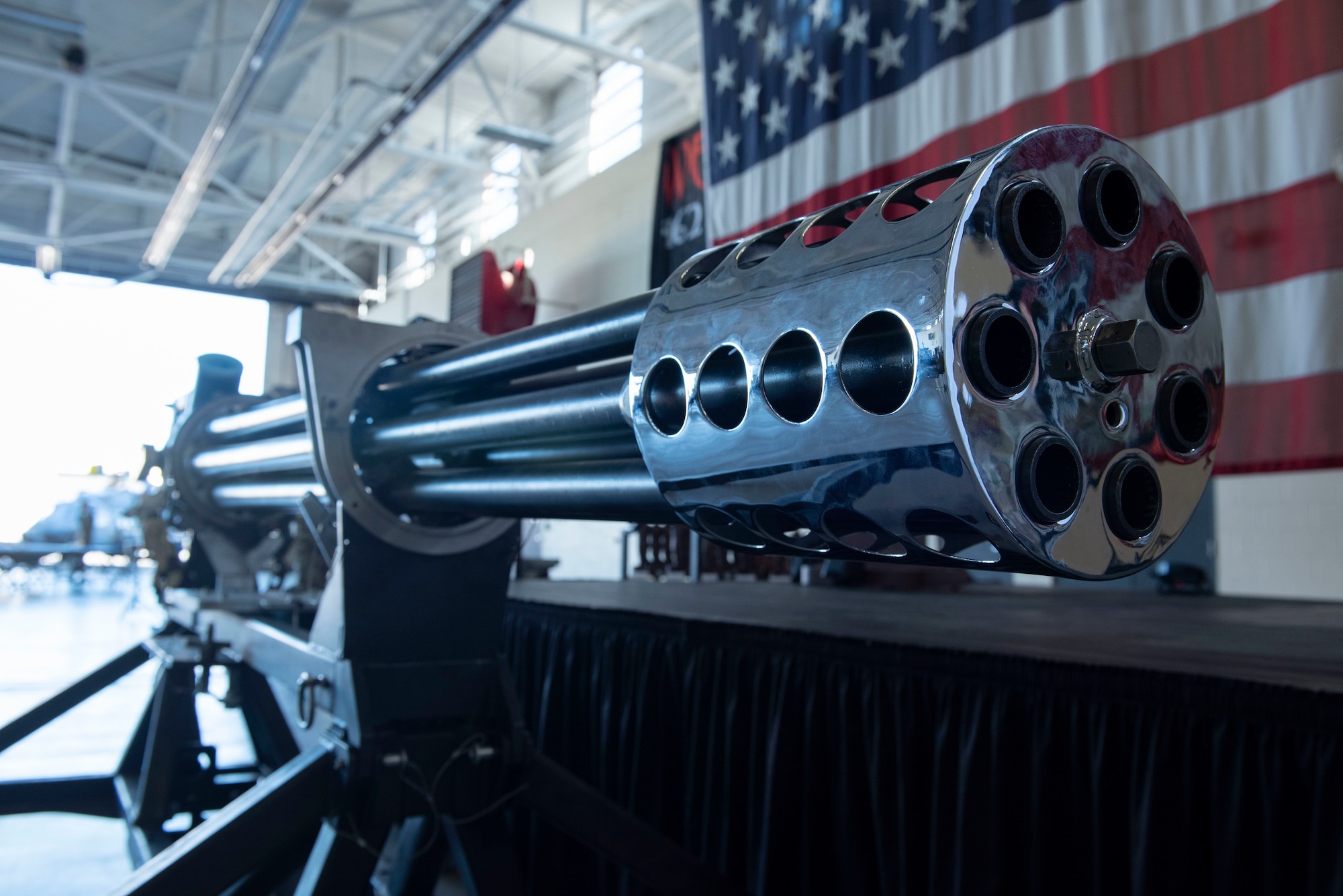 A stylized GAU-8 Avenger 30mm gatling gun rests in front of the presentation stage during the Maintenance Professional of the Year awards banquet at Moody Air Force Base, Georgia, March 25, 2022. Maintenance Airmen maintain, arm, and ensure readiness for U.S. Air Force aircraft. (U.S. Air Force photo by Senior Airman Thomas Johns)