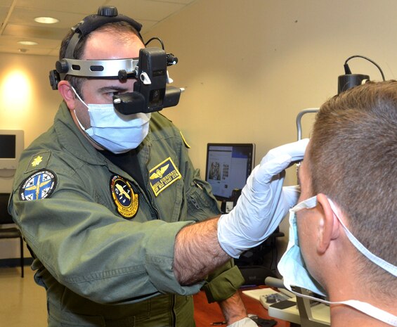 Lt. Cmdr. Michael Kerekgyarto, an optometrist at Naval Branch Health Clinic Jacksonville, conducts an eye exam with Aviation Structural Mechanic 2nd Class Joshua Khirfan, of Patrol Squadron 45.