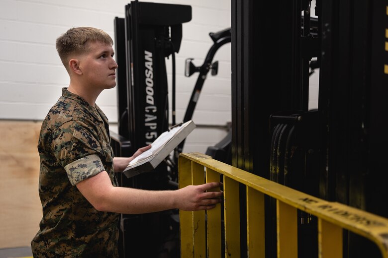 U.S. Marine Corps Cpl. Christian Jenkins, quality assurance safety observer with Headquarters and Headquarters Squadron, Marine Corps Air Station (MCAS) New River, Jacksonville, North Carolina, conducts a routine inspection on a forklift on MCAS New River in Jacksonville, North Carolina, March 24, 2022. Jenkins, the recipient of the March MCAS New River Go-Getter award, enlisted in the Marine Corps in 2018 from Sidney, Ohio. (U.S. Marine Corps photo by Lance Cpl. Antonino Mazzamuto)