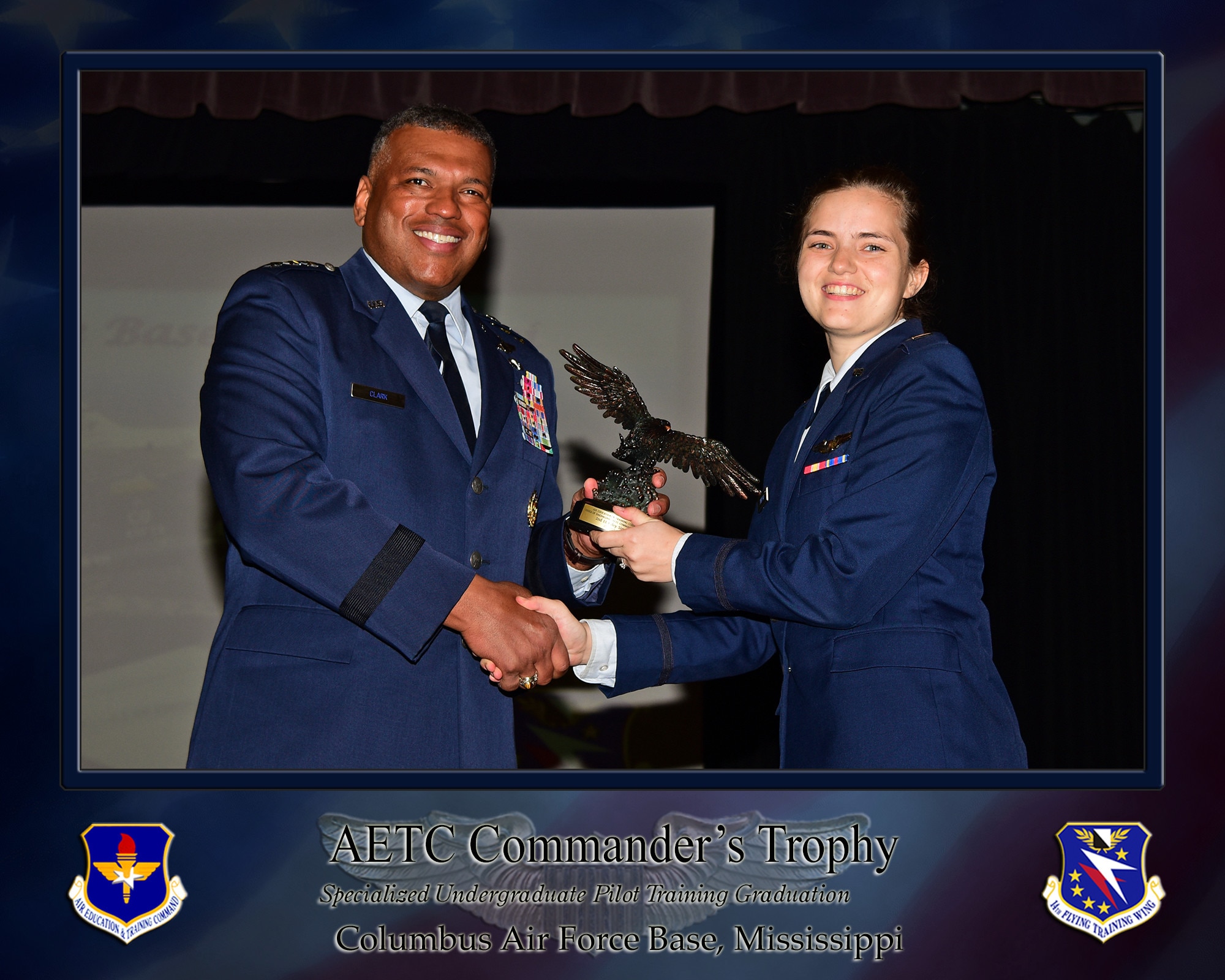 U.S. Air Force Lt. Gen. Richard M. Clark, USAF Academy superintendent, presents 2nd Lt. Riley Simpson, SUPT graduate, with an AETC Commander's Trophy, Mar. 25, 2022 on Columbus Air Force Base, Miss. Simpson was one of three recipients of the award for being the most outstanding students overall in their classes. (U.S. Air Force photo by Melissa Duncan-Doublin)