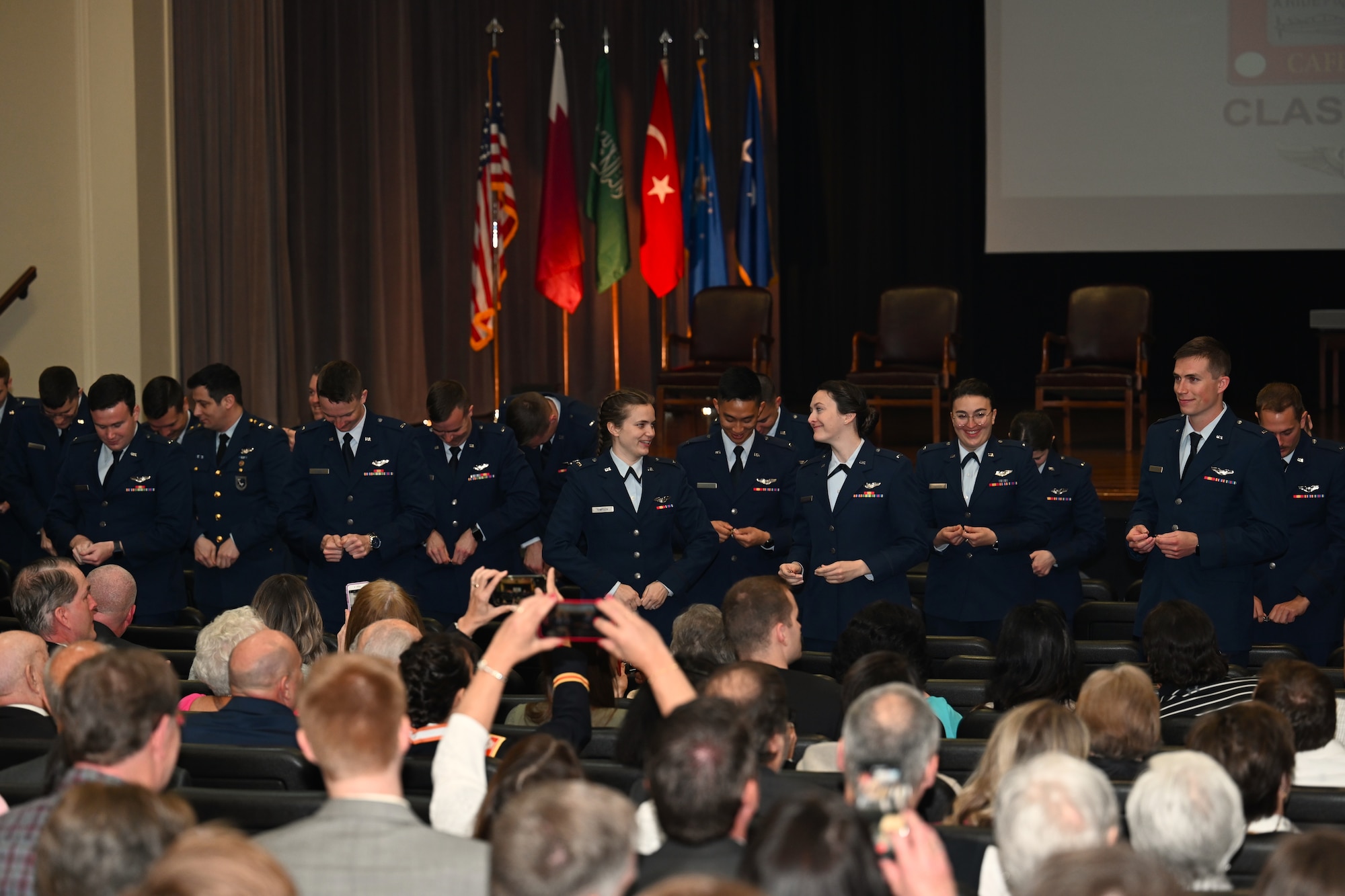 Graduates from Specialized Undergraduate Pilot Training class 22-07, break their first pair of wings, during their graduation ceremony, Mar. 25, 2022 on Columbus Air Force Base, Miss. During a long-standing aviation tradition, pilots will keep one half of the broken wings and give the second half to a loved one. The two halves are never to be brought back together while the pilot is still alive. (U.S Air Force photo by Airman 1st Class Jessica Haynie)