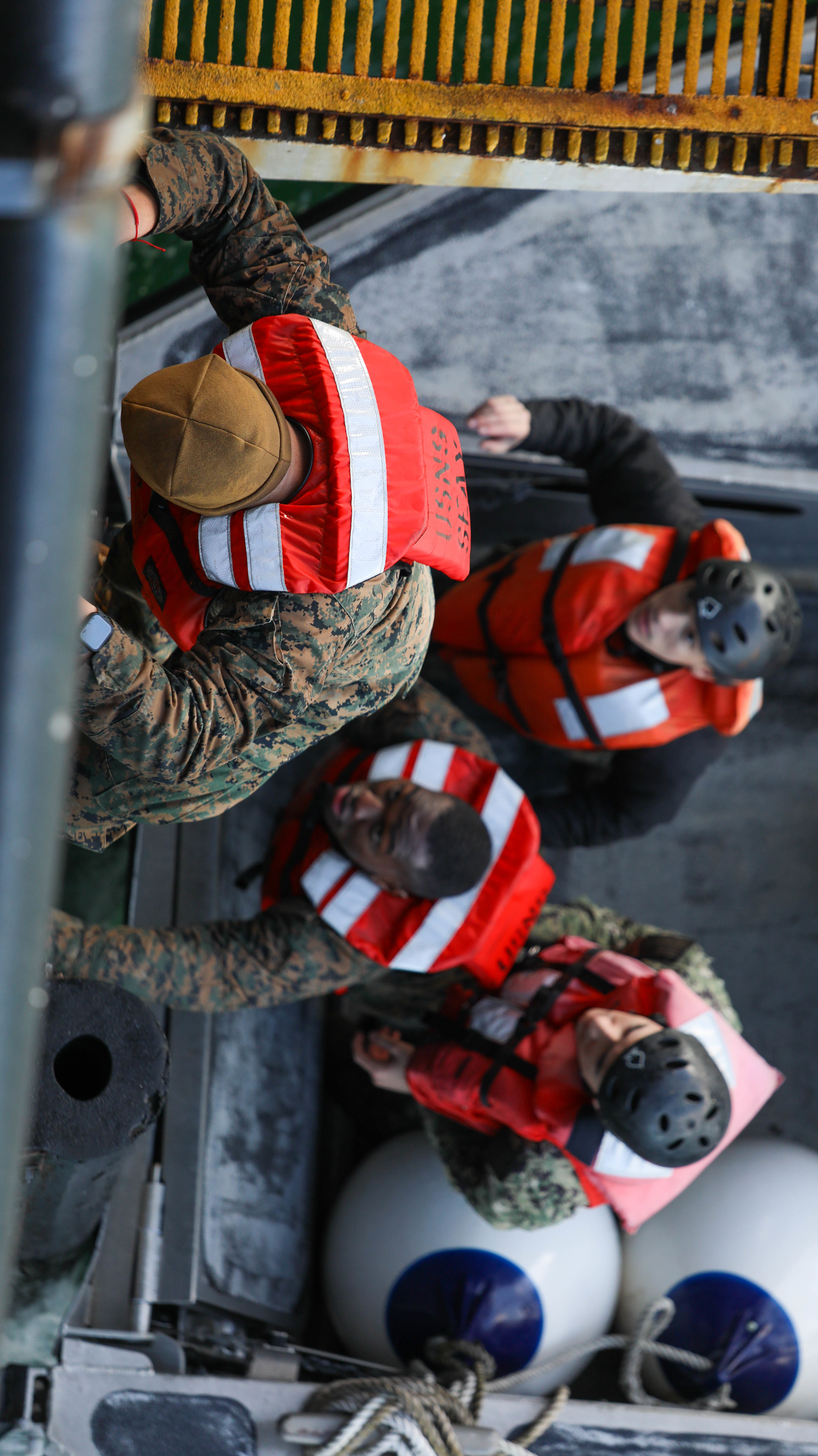 U.S. Navy Sailors with assault craft unit 2, Maritime Preposition Force department, assist U.S Marines with 3rd Marine Logistics Group to climb aboard the USNS 1st Lt Jack Lummus (T-AK 3011) during exercise Atlantic Dragon on Marine Corps Support Facility Blount Island, Florida, United States, March 15, 2022.