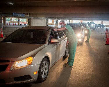 Brooke Army Medical Center medics screen patients at the BAMC COVID-19 drive-through testing site, Fort Sam Houston, Texas, Aug. 6, 2021.