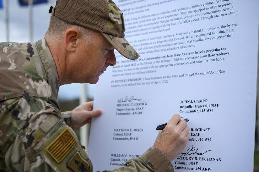 Col. Tyler Schaff, 316th Wing and installation commander, signs the proclamation dedicated to the month of the Military Child, April 1, 2022, at Joint Base Andrews, Md.