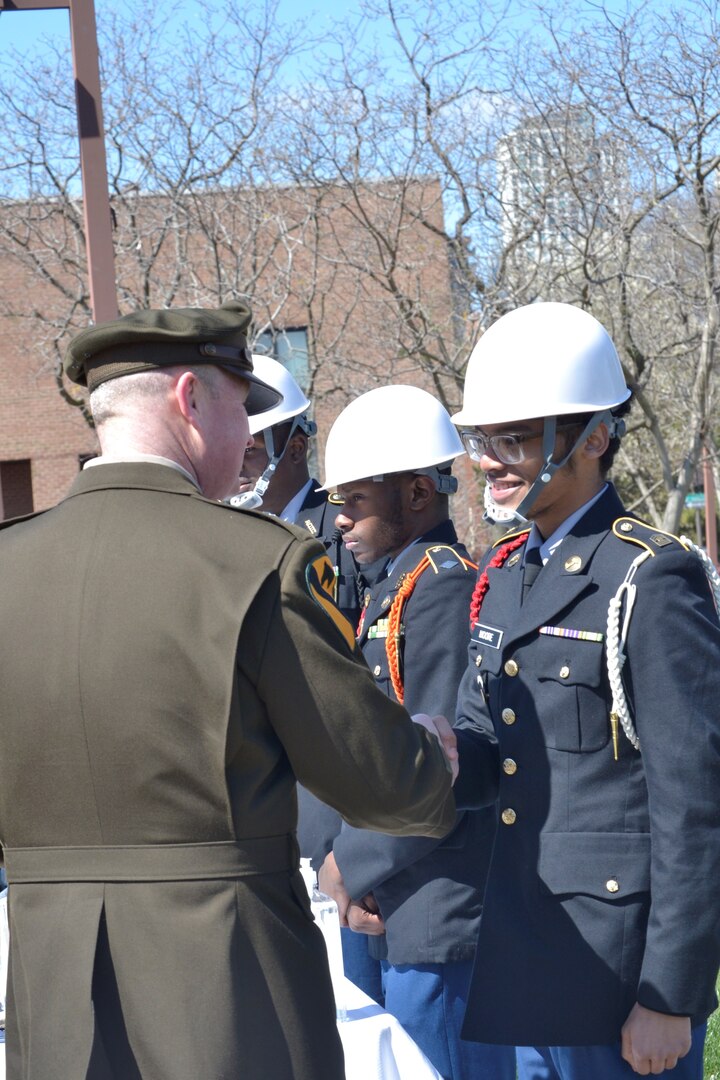 Army offer shakes hand of ROTC cadet