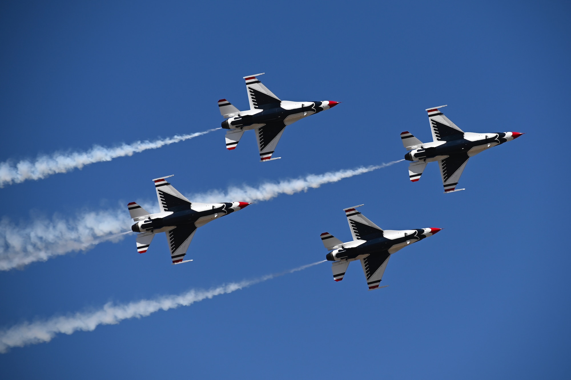 The USAF Thunderbird aircraft performers aerial maneuvers during the Wings Over Columbus 2022 Airshow March 25, 2022, on Columbus Air Force Base, MS. Eight officers serve as the Thunderbirds highly experienced pilots, and four serve in critical roles from medical support to public affairs. (U.S. Air Force photo by Senior Airman Jake Jacobsen)