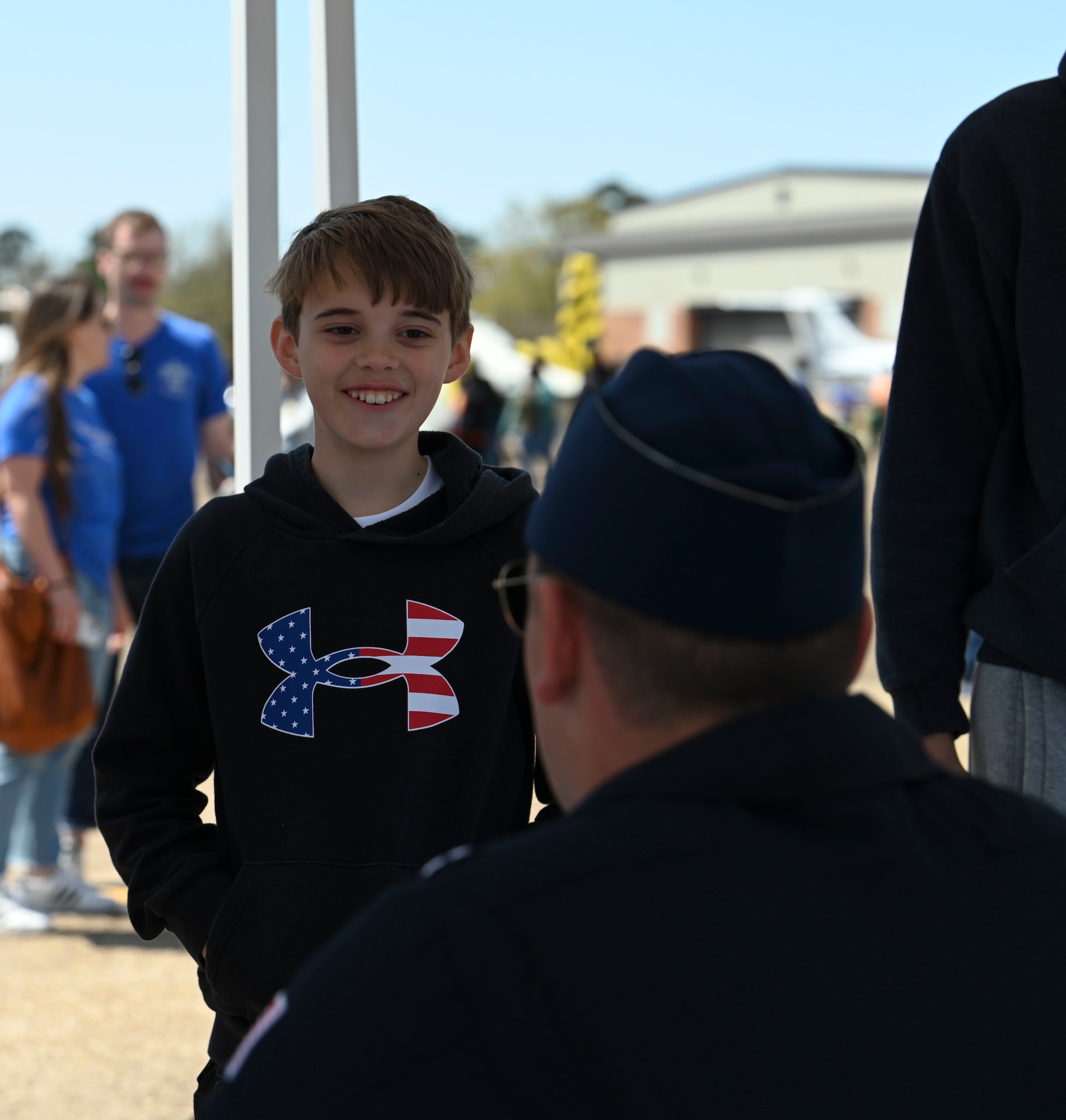 An attendee at the Wings Over Columbus Airshow receives a signature and talks with Capt. Daniel Katz, United States Air Force Demonstration Team pilot, Mar. 26, 2022, on Columbus Air Force Base, Miss. Katz is the Opposing Solo Pilot for the USAF Thunderbirds, flying the No. 6 jet. (U.S. Air Force photo by Airman 1st Class Jessica Haynie)