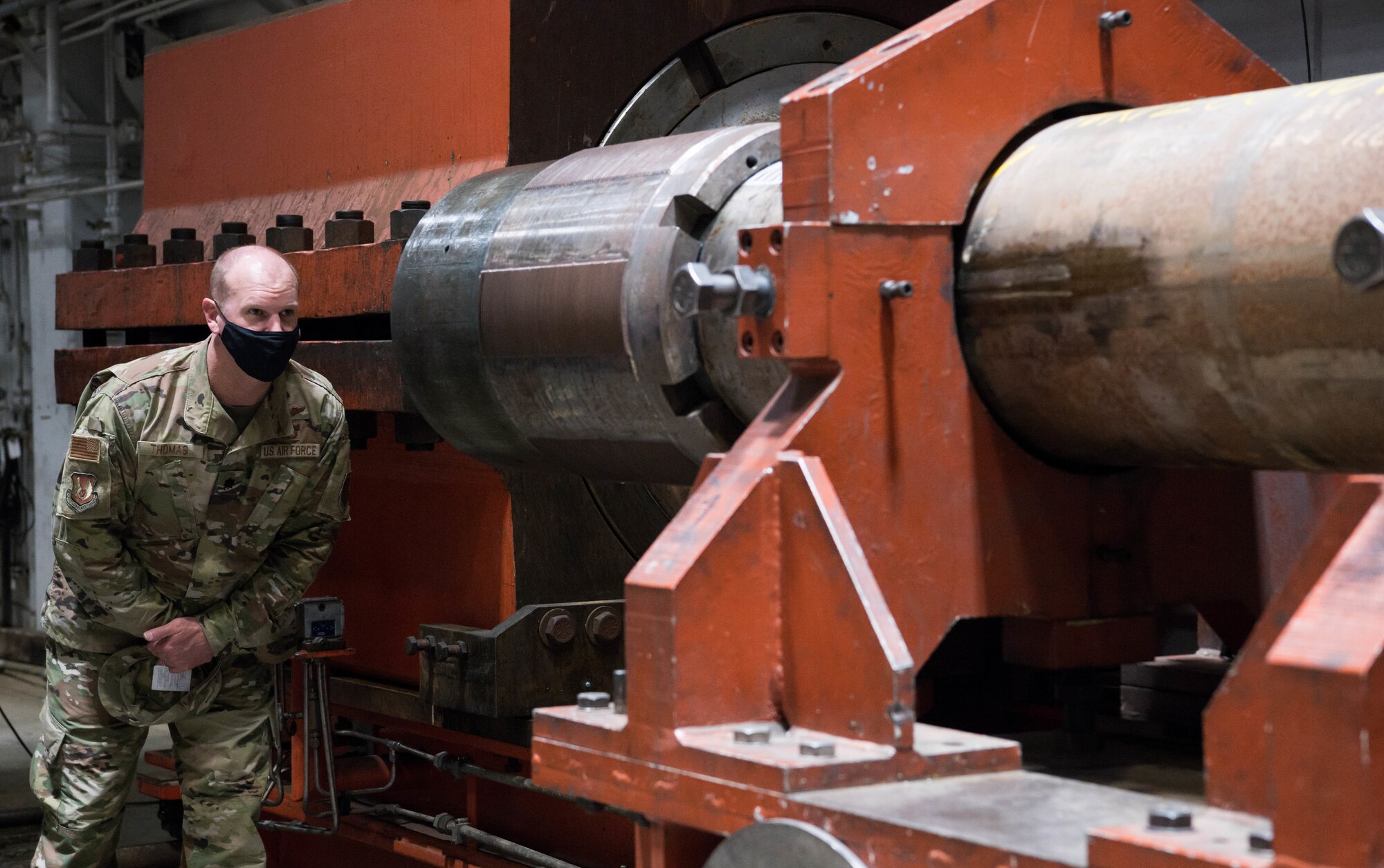 Thomas looking down large gun barrel