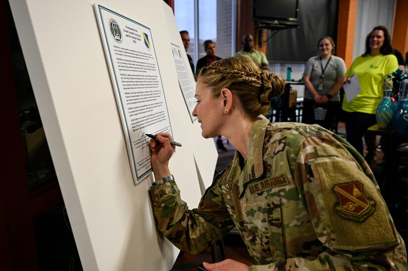 U.S. Air Force Chief Master Sgt. Christy Peterson, Joint Base Anacostia-Bolling and 11th Wing command chief, signs a proclamation signifying Sexual Assault Awareness and Prevention Month at JBAB, Washington, D.C., March 31, 2022.