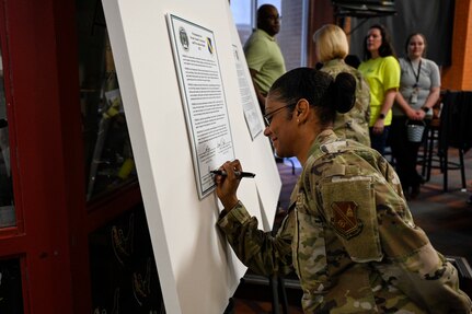 U.S. Air Force Chief Master Sgt. Christy Peterson, Joint Base Anacostia-Bolling and 11th Wing command chief, signs a proclamation signifying Sexual Assault Awareness and Prevention Month at JBAB, Washington, D.C., March 31, 2022.