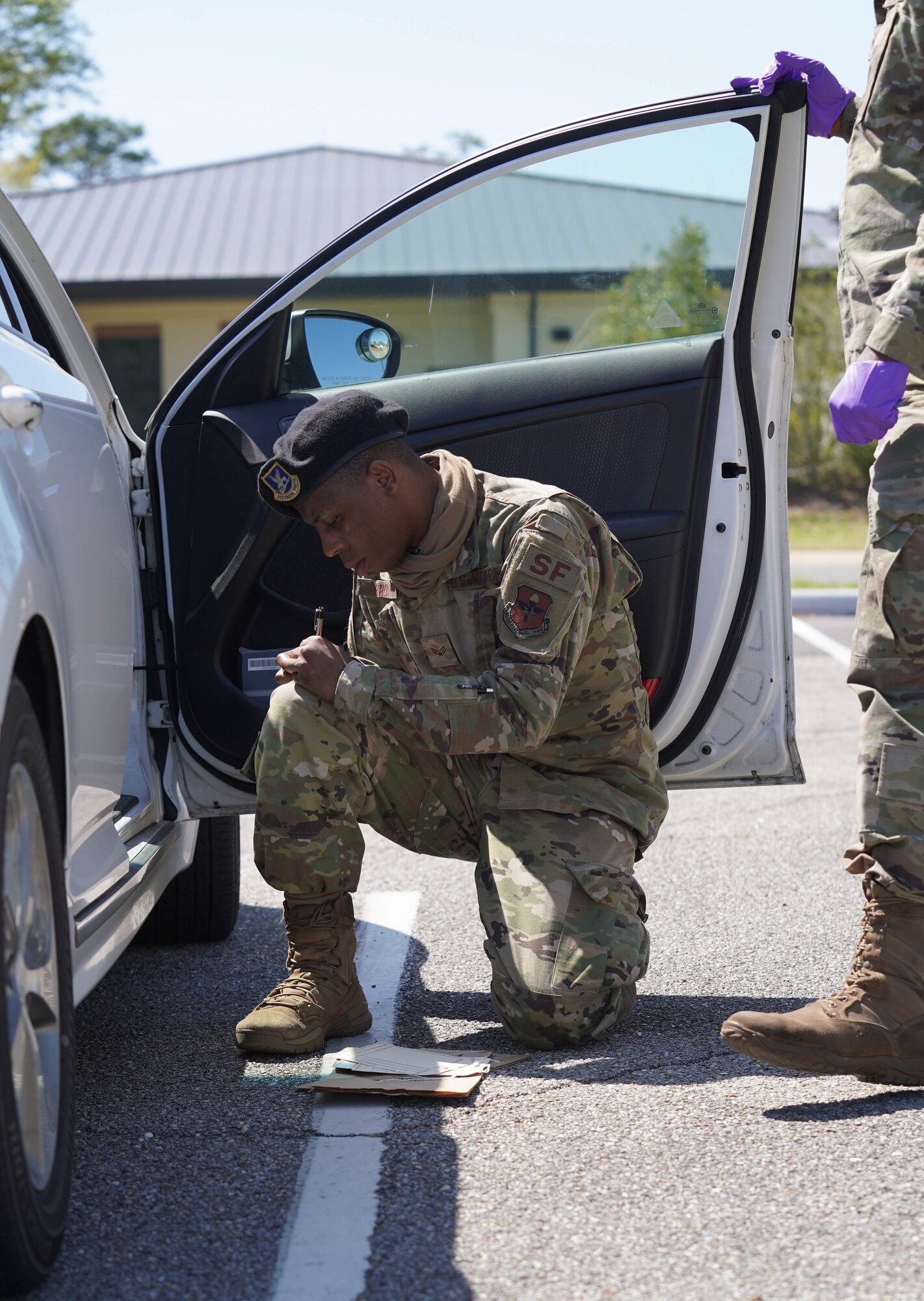U.S. Air Force Senior Airman Darian Brown, 81st Security Forces Squadron patrolman, examines evidence in a mock crime scene at Keesler Air Force Base, Mississippi, March 28, 2022. Brown participated in this training to improve his skills as a security forces member in the event he was called for a court martial. (U.S. Air Force photo by Airman 1st Class Elizabeth Davis)
