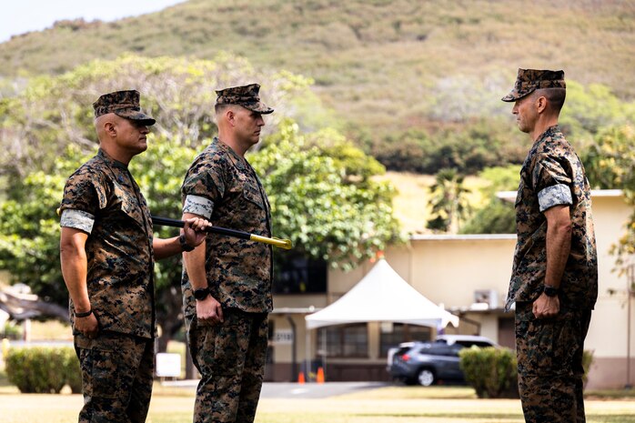 U.S. Marine Corps Sgt. Maj. Jose Romero, left, offgoing sergeant major, Headquarters Battalion, Marine Corps Base Hawaii, Sgt. Maj. Matthew Kidder, middle, incoming sergeant major, and Lt. Col. Stephen McNeil, right, commanding officer, Headquarters Battalion, MCBH, conduct a relief and appointment ceremony, MCBH, March 30, 2022. Romero was relieved as the sergeant major of Headquarters Battalion by Kidder. (U.S. Marine Corps photo by Cpl. Brandon Aultman)