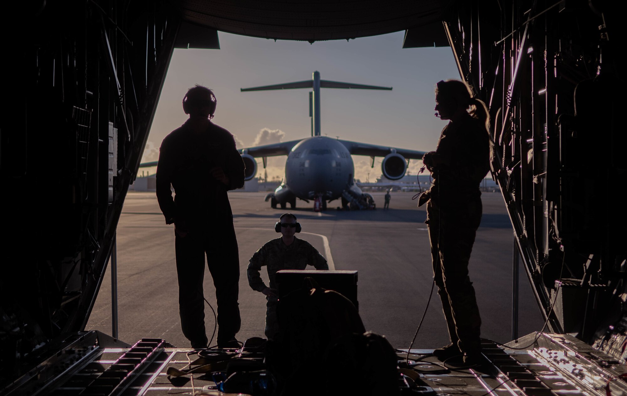 U.S. Air Force Senior Master Sgt. Chuck Davis, left, and Airman 1st Class Skye Luck, Nevada Air National Guard loadmasters, at the ramp of a Nevada C-130 Hercules Aircraft after completing a training mission at Hickam Air Force Base, Hawaii, March 2, 2022. Airmen from various squadrons and groups from the Nevada Air National Guard participated in an exercise to employ the agile combat employment concept across various Hawaiian Islands.