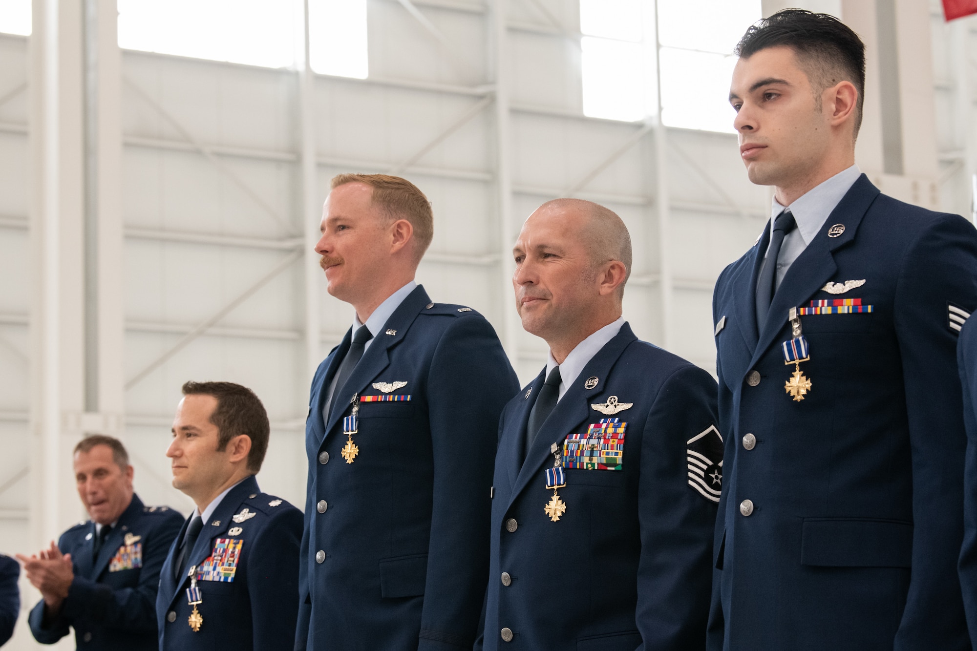 The Air Force Reserve Command deputy commander awards the Distinguished Flying Cross to four C-17A Globemaster III aircrew members during a ceremony at Travis Air Force Base, Calif., Apr. 1, 2022. 
Three Reserve Citizen Airmen assigned to the 349th Air Mobility Wing at Travis, and an active duty Airman from the 3rd Wing, Joint Base Elmendorf-Richardson, Alaska, were recognized for answering their nation’s call when they helped evacuate Americans and their allies out of Afghanistan during Operation Allies Refuge in August 2021.
During the ceremony, Maj. Gen. Matthew J. Burger, the former commander of the 349th AMW, presented the medals to Lt. Col. Dominic Calderon, 1st Lt. Kyle Anderson and Master Sgt. Silva Foster, from the 301st Airlift Squadron, and Senior Airman Michael Geller of the 517th Airlift Squadron. 
(U.S. Air Force photo by Grant Okubo)