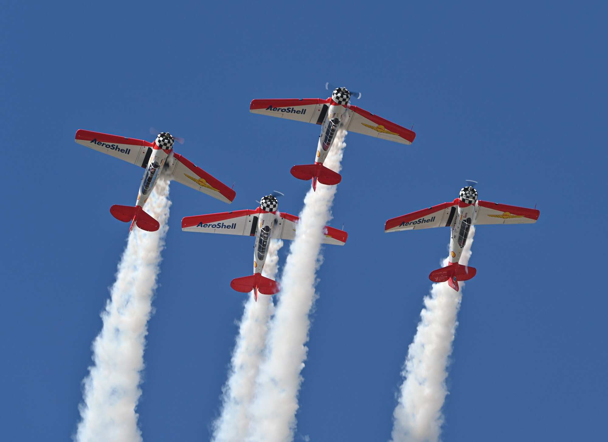 The AeroShell Aerobatic Team performs an aerial maneuver at the 2022 Wings Over Columbus Airshow on March 26, 2022, at Columbus Air Force Base, Miss. The AeroShell Aerobatic Team performs tight formation aerial maneuvers in front of millions of airshow fans all over North America. (U.S. Air Force photo by Senior Airman Davis Donaldson)