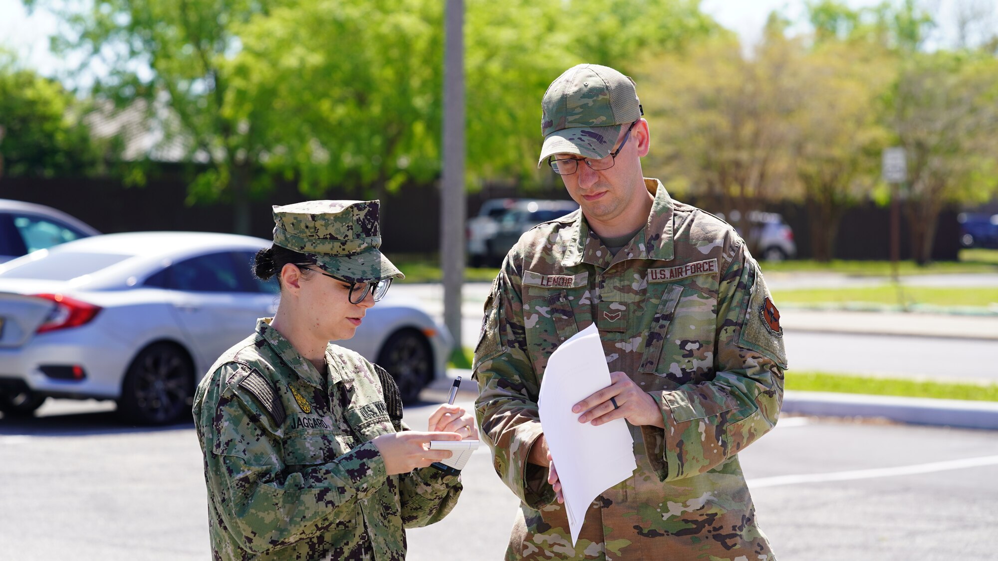 U.S. Air Force Airman 1st Class Thomas Lenior, 81st Training Wing military justice paralegal, and U.S. Navy Master at Arms Petty Officer Third Class Jordan Jaggard, security forces patrolman, participate in a mock crime scene at Keesler Air Force Base, Mississippi, March 28, 2022. Participants practiced gathering evidence and writing statements to be used in a courtroom. (U.S. Air Force photo by Airman 1st Class Elizabeth Davis)