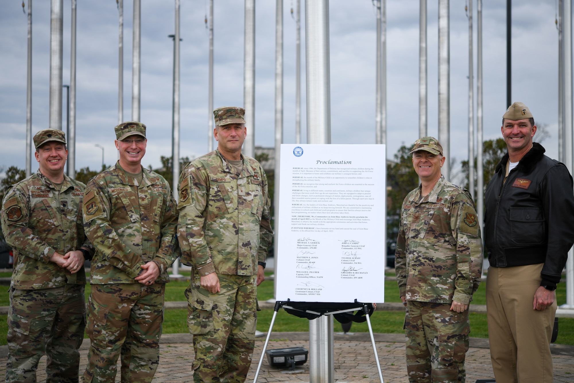 Joint Base Andrews senior leadership pose for a photo during a proclamation signing dedicated to the month of the Military Child, April 1, 2022, at Joint Base Andrews, Md.