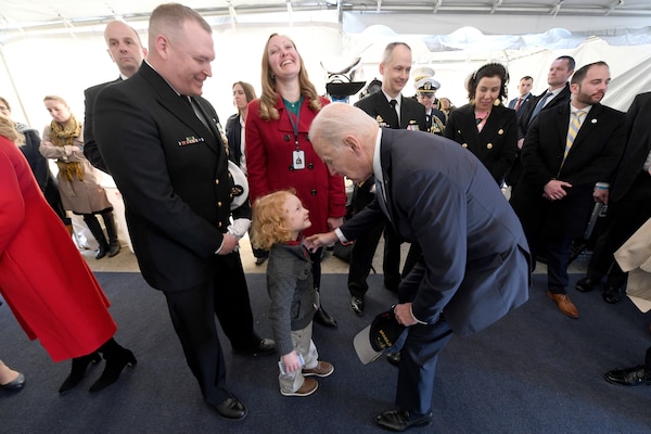President of the United States Joe Biden is greeted by Senior Chief Petty Officer Travis Grammer, chief of the boat for the Virginia-class submarine USS Delaware (SSN 791), and his family during a commissioning commemoration ceremony in Wilmington, Delaware April 2, 2022.