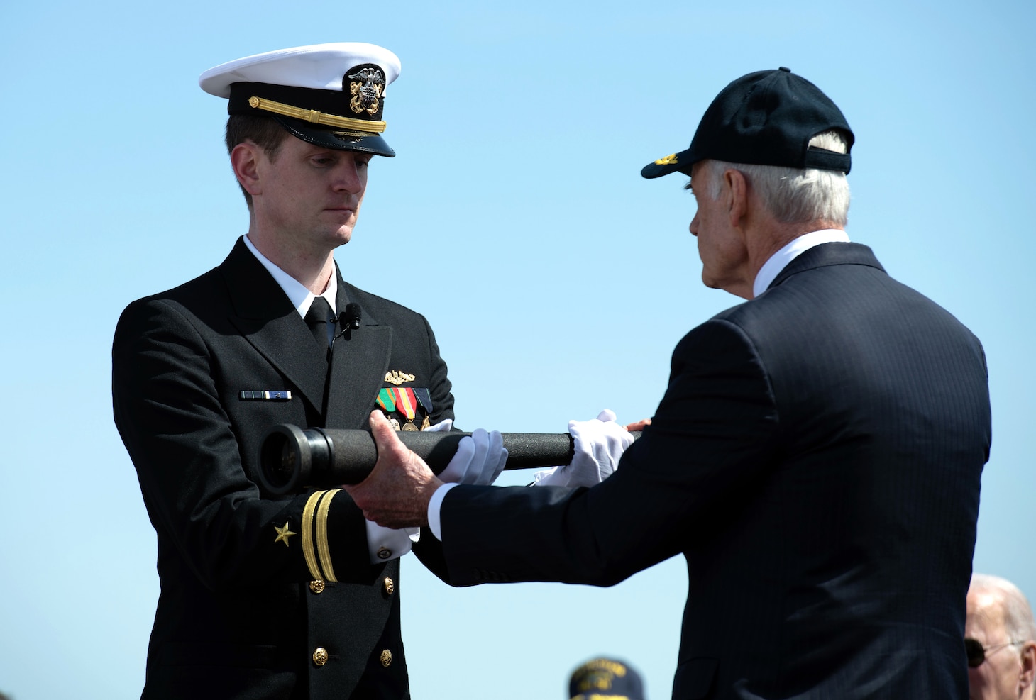 U.S Sen. Tom Carper of Delaware presents a ceremonial spyglass to Lt. Stephen Walsh during a commissioning commemoration ceremony for the Virginia-class submarine USS Delaware (SSN 791) in Wilmington, Delaware April 2, 2022.