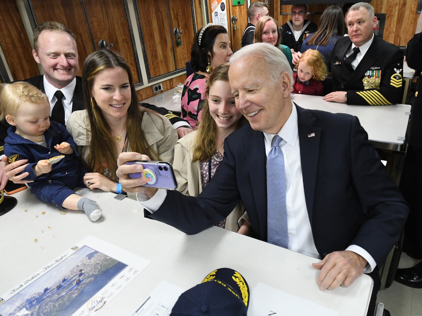 President of the United States Joe Biden takes a selfie with Lt. Cmdr. Adam Parkinson and his family on board the Virginia-class submarine USS Delaware (SSN 791) following a commissioning commemoration ceremony in Wilmington, Delaware April 2, 2022.