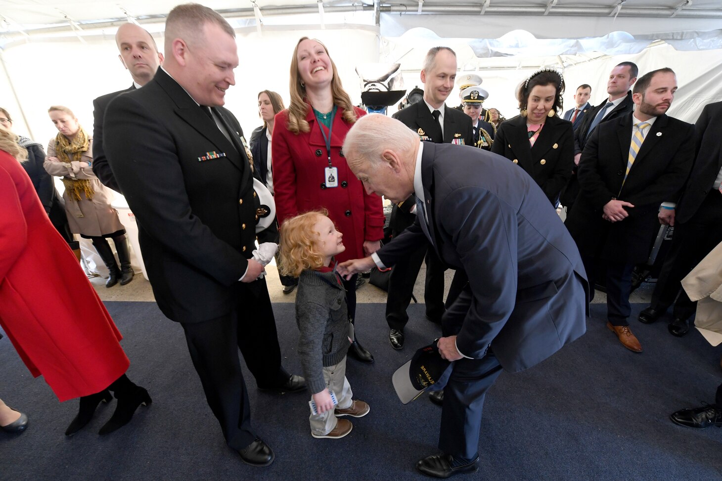 President of the United States Joe Biden is greeted by Senior Chief Petty Officer Travis Grammer, chief of the boat for the Virginia-class submarine USS Delaware (SSN 791), and his family during a commissioning commemoration ceremony in Wilmington, Delaware April 2, 2022.