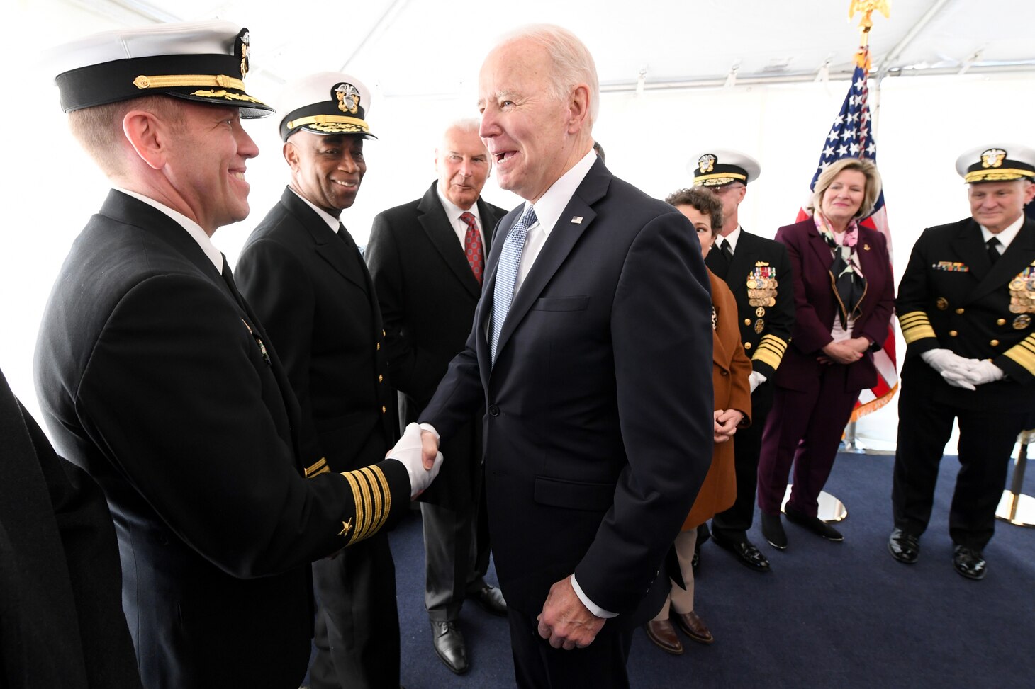 President of the United States Joe Biden is greeted by Submarine Squadron 12 commander Capt. Matthew Boland during a commissioning commemoration ceremony for the Virginia-class submarine USS Delaware (SSN 791) in Wilmington, Delaware April 2, 2022.