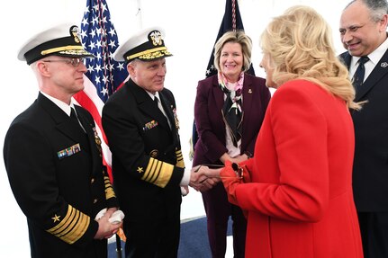 First Lady Jill Biden is greeted by Chief of Naval Operations Adm. Mike Gilday and Adm. Daryl Caudle, commander, U.S. Fleet Forces Command, during a commissioning commemoration ceremony for the Virginia-class submarine USS Delaware (SSN 791) in Wilmington, Delaware April 2, 2022.