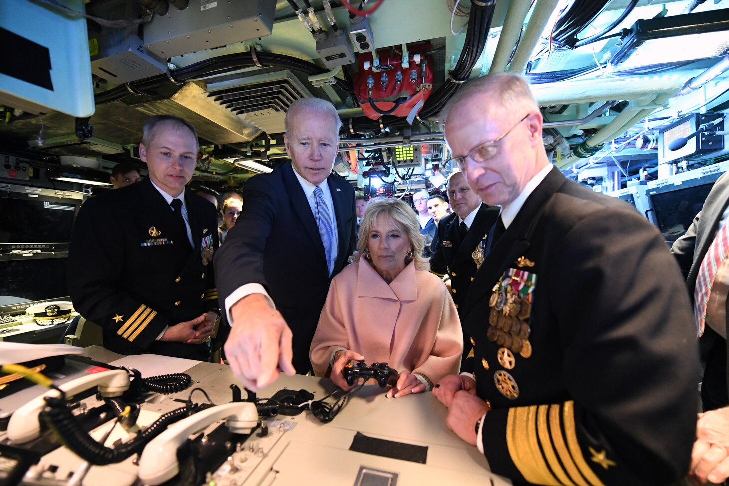 President of the United States Joe Biden and First Lady Jill Biden operate the periscope using a video game controller alongside U.S. Fleet Forces commander Adm. Daryl Caudle, right, and Cmdr. Matthew Horton, commanding officer of the Virginia-class submarine USS Delaware (SSN 791), following a commissioning commemoration ceremony in Wilmington, Delaware April 2, 2022.