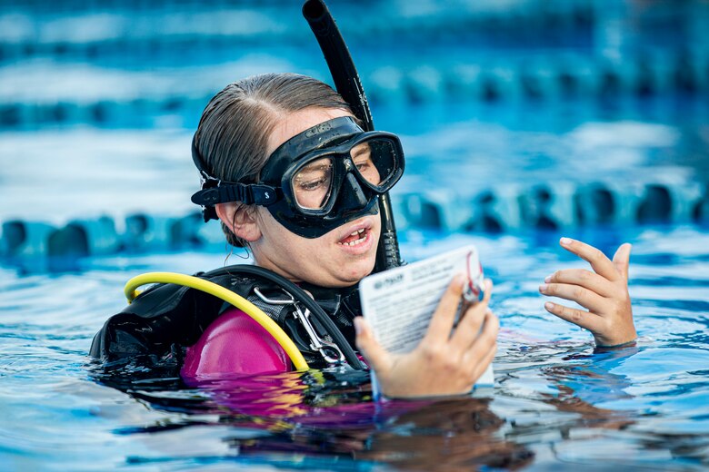 U.S. Marine Corps Cpl. Madeline Prine, an automotive maintenance technician with 7th Communication Battalion, III Marine Expeditionary Force Information Group, reviews scuba diving techniques on Camp Schwab, Okinawa, Japan, March 24, 2022. Prine is a certified scuba instructor through the Professional Association of Diving Instructors. (U.S. Marine Corps photo by Cpl. Alex Fairchild)