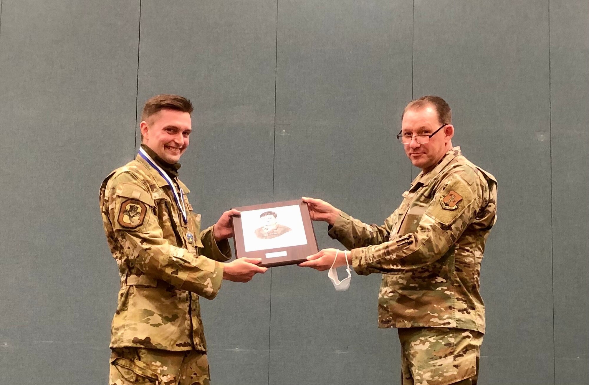 Chief Master Sgt. Scott Ross, the command chief of the 178th Wing, right, presents Tech. Sgt. Seth Loppe, a sensor operator assigned to the 178th Operations Group, with the John L. Levitow for excellence in professional military education May 12, 2021 at Springfield-Beckley Air National Guard Base in Springfield, Ohio. Loppe graduated from Noncomissioned Officer Academy in March of 2021 with an academic average of 100 percent which earned him the spot as the top graduate in a class of approximately 240 Airmen. (Courtesy photo)