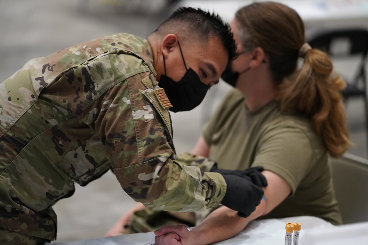 California Air National Guard Airman 1st Class Mark Duhaylongsod, Medical Technician with the 146th Medical Group, prepares to do a blood draw on Master Sgt. Katie Palmer of the 146th Operations Support Squadron at the PHAG2R (Periodic Health Assessment Go 2 Ready) at Channel Islands Air National Guard Station (CIANGS), Port Hueneme, California. November 6, 2021. This two-day event is the first annual PHAG2R for CIANGS. It's objective is to increase efficiency for airmen to complete their medical requirements, maintaining readiness and deployabilty for the whole year in a one-stop shop.