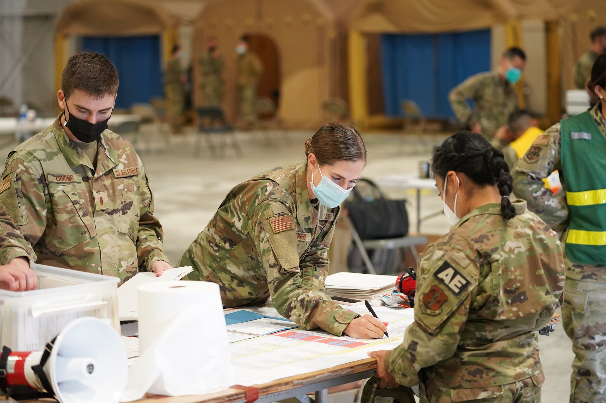 California Air National Guard 2nd Lt. Joy Bricker and 2nd Lt. Logan Landes with the 146th Medical Group check in Master Sgt. Crystal Streets with the 146th AES (Aeromedical Evacuation Squadron) at the PHAG2R (Periodic Health Assessment Go 2 Ready) at Channel Islands Air National Guard Station (CIANGS), Port Hueneme, California. November 6, 2021. This two-day event is the first annual PHAG2R for CIANGS. It's objective is to increase efficiency for airmen to complete their medical requirements, maintaining readiness for the whole year in a one-stop shop.