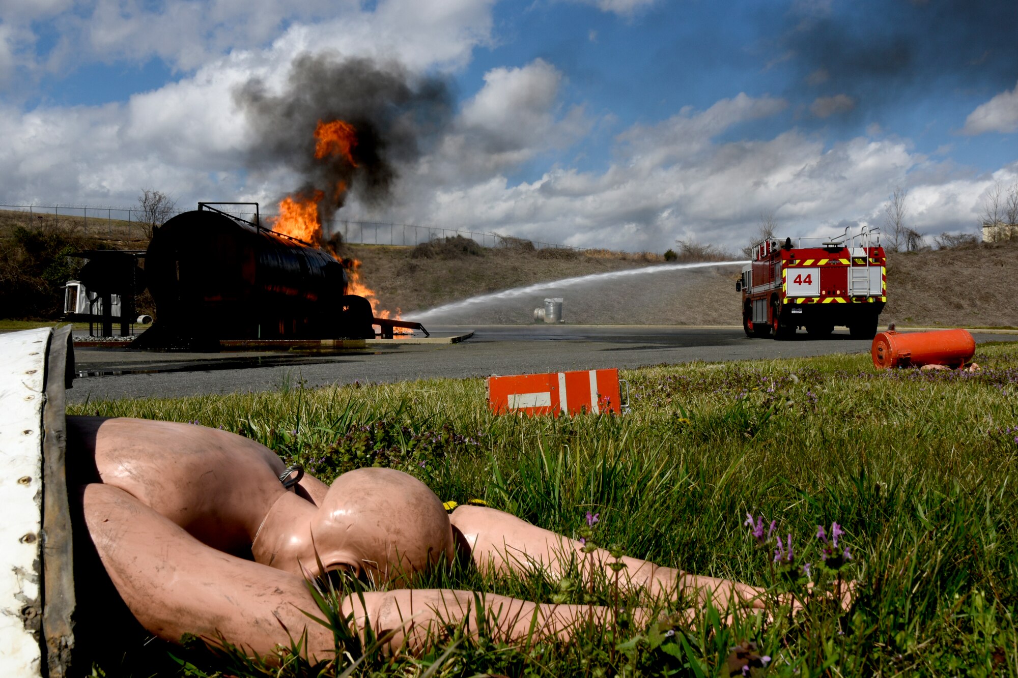 U.S. Airmen assigned to the North Carolina Air National Guard (NCANG), 145th Civil Engineering Squadron (CES), respond to and attempt to extinguish a simulated aircraft mishap just outside the NCANG Base, Charlotte Douglas International Airport, Mar. 6, 2022. The 145th CES coordinated with the Charlotte Fire Department and other local authorities to simulate an aircraft mishap and what steps to handle in the event of such a disaster. This is the first exercise of this kind since the 1990s involving many moving parts including local fire departments, Emergency Management and the 145th Airlift Wing.