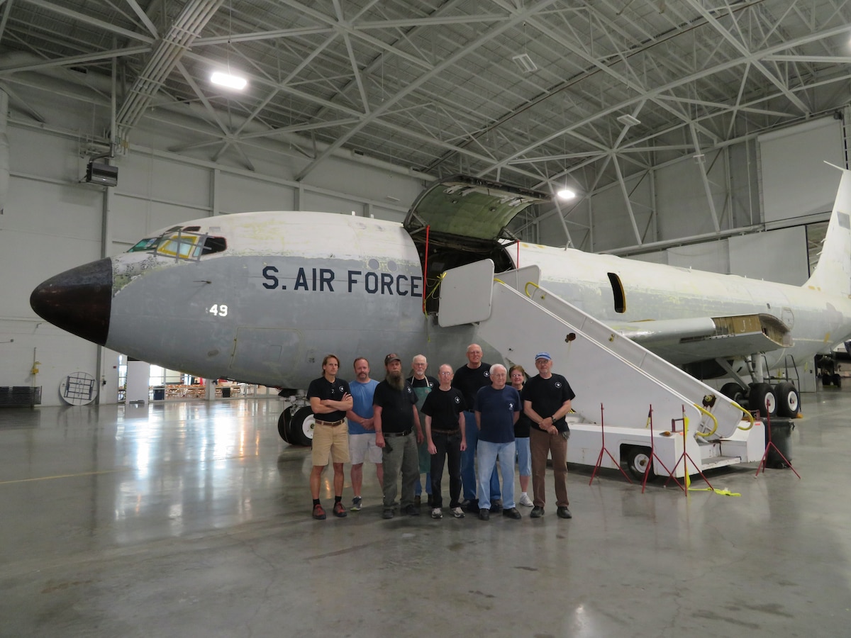 Group of men and women standing in front of EC-135C "Looking Glass" aircraft