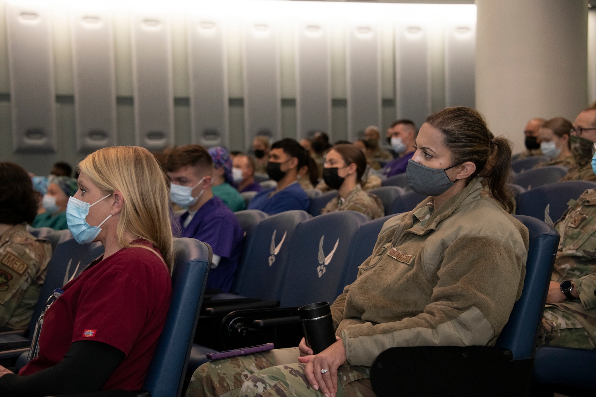 U.S. Airmen attend the David Grant USAF Medical Center all call at Travis Air Force Base, California, March 31, 2022.  Airmen listened to senior leadership address changes to USAF medical standards. (U.S. Air Force phot o by Heide Couch)