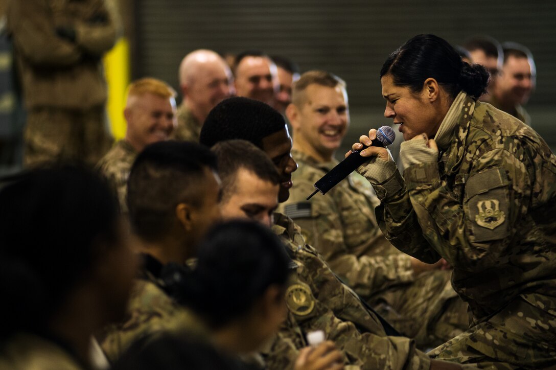 Airman musician singing to deployed troops