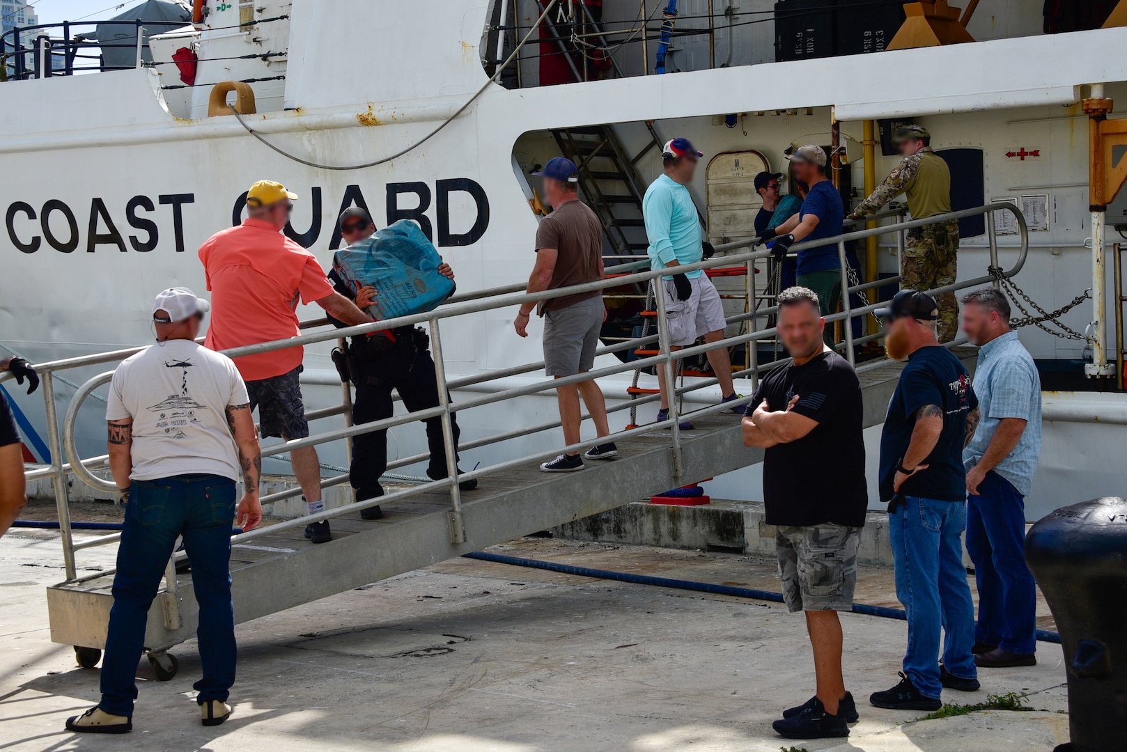 U.S. Coast Guard Cutter Dauntless' (WMEC-624) crewmembers offload bales of illegal narcotics on to pallet at Base Miami Beach, Florida, April 1, 2022