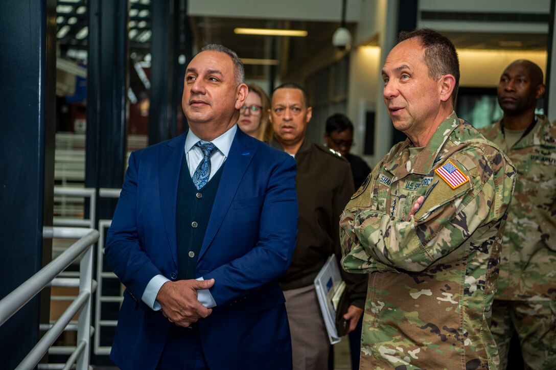 U.S. Space Force Lt. Gen. John Shaw, U.S. Space Command Deputy Commander, discusses space capabilities on display with the Honorable Gilbert R. Cisneros, Jr., Undersecretary of Defense for Personnel and Readiness March 30, 2022, at USSPACECOM headquarters.