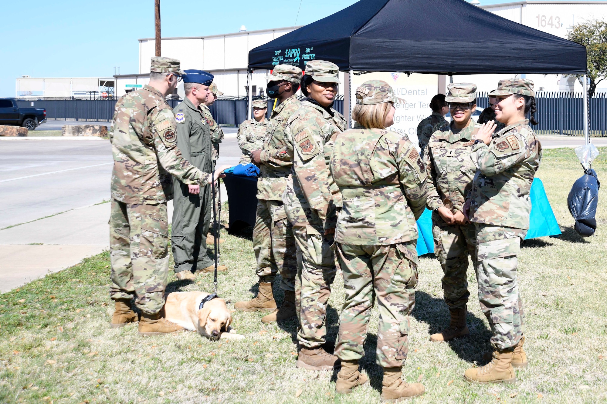 301 st Fighter Wing Airman talk during the Sexual Assault Prevention and

Response meet and greet at Naval Air Station Joint Reserve Base Fort Worth, Texas, April 2, 2022. The SAPR team provided free coffee, donuts, and informational merchandise to spread awareness on sexual assault.