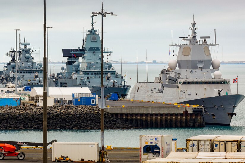 Ships sit moored in a harbor.